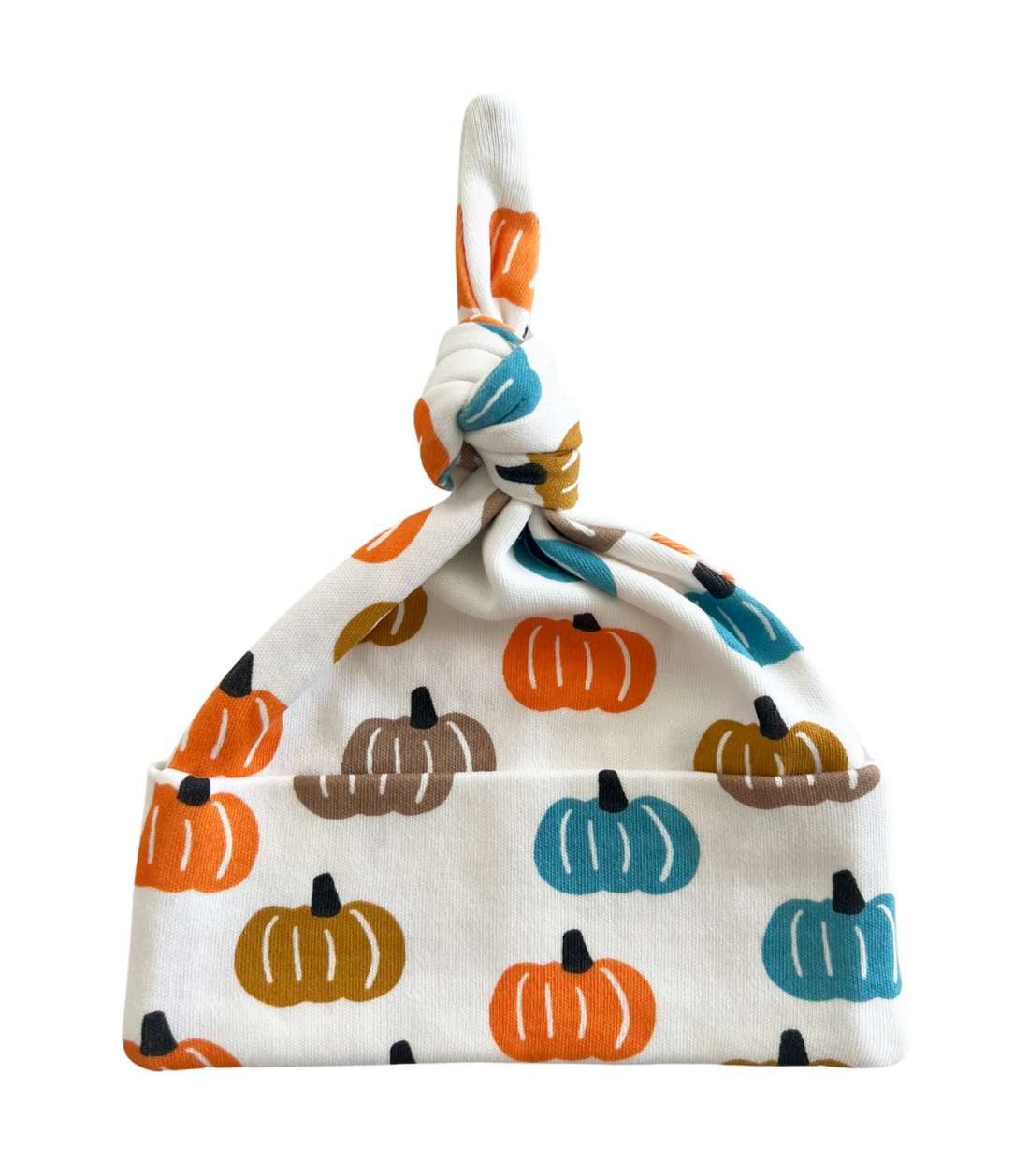 A baby knit hat with a knotted top and a folded brim, featuring an all-over pumpkin print in orange, teal, brown, and mustard on a white background.