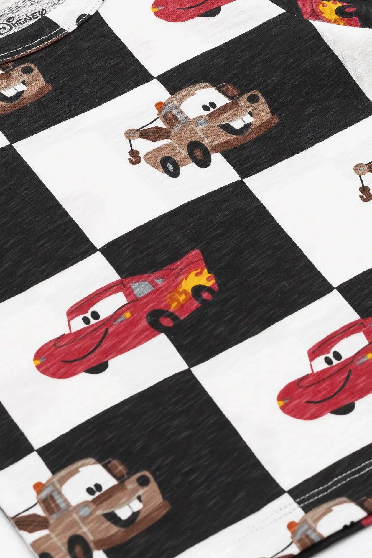 Checkered fabric with cartoon cars and trucks on a white and black checkered background