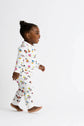 Child wearing a colorful pajama set with a white background